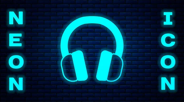 Ragyogó Neon Fejhallgató Ikon Elszigetelt Téglafal Háttér Fülhallgató Koncepció Zenehallgatáshoz — Stock Vector