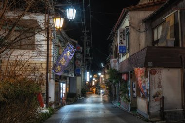 Shibu Onsen taken at night. A historic and traditional hot spring town located in Nagano prefecture in Japan. Various ryokans and stores along the street lit up. Taken on January 22 2023.
