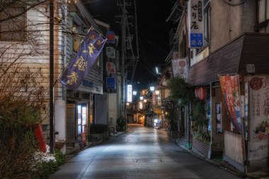 Shibu Onsen taken at night. A historic and traditional hot spring town located in Nagano prefecture in Japan. Various ryokans and stores along the street lit up. Taken on January 22 2023.