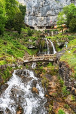 Saint Beatus mağara girişi ve yakınlardaki şelale. Interlaken, İsviçre 'de çekilmiş.