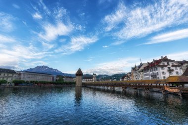 the view of chapel bridge over the Reuss river at sunrise. Famous landmark in Lucerne, Switzerland. Taken on May 27 2024 clipart