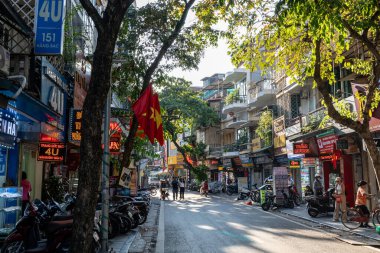 Hanoi Old Quarters caddesinde çeşitli dükkanlar, sayısız scooter ve yayalar var. Hanoi, Vietnam 'da 27 Ağustos 2024' te çekildi.