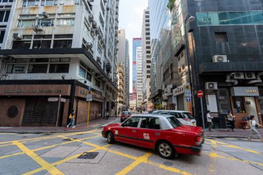 Hong Kong 'da bir kavşakta kırmızı taksiler. 9 Eylül 2024 'te Merkez Bölgede çekildi.