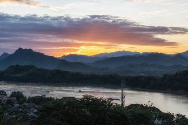 View of sunset over the mekong river and Luang Prabang taken from Phousi Hill. Famous tourist destination in Luang Prabang, Laos clipart