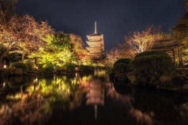 Toji temple gojunoto pagoda or five story pagoda taken at night during autumn season. Famous temple pagoda in Kyoto, Japan clipart