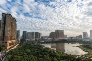 Cotai Strip and surrounding casinos and hotel viewed from across the ecological pond in Taipa, Macao. Taken on December 16 2024 clipart