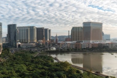 Cotai Strip and surrounding casinos and hotel viewed from across the ecological pond in Taipa, Macao. Taken on December 16 2024 clipart