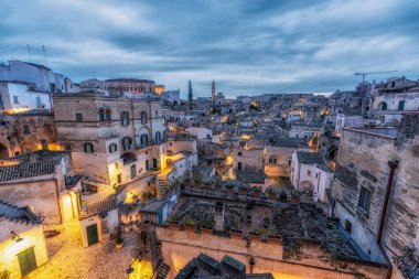 Sassi di Matera 'nın gündoğumu manzarası. Birbirine bağlı geniş mağara evleri dar sokaklar boyunca. Matera, İtalya 'da ünlü ikonik cazibe