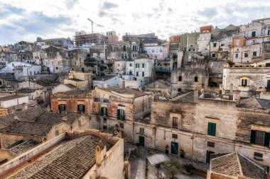 View of Sassi di Matera. Interconnected vast areas of cave dwellings homes along narrow streets. Famous iconic attraction in Matera, Italy clipart