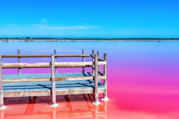 stock image Salt production, pink lagoon and hills in the Mediterranean sea is located in Aigues-Mortes . Camargue, France. Hight quality photo