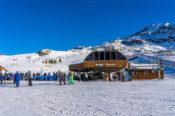 Alpe D'Huez, FRANCE - 01.01.2022: Famous ski resort in French Alps, France, Europe. Skiers skiing on the mountain, ski lift, family sports weekend, holidays in the snow mountains concept. Winter times