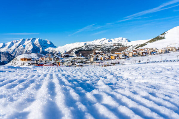 Famous ski resort in French Alps, France, Europe. Skiers skiing on the mountain, ski lift, family sports weekend, holidays in the snow mountains concept. Winter times