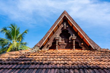 Carving wood gable roof on a resort hotel in India, Alappuzha, Kerala. Wooden roof structure, traditional indian style. Eco design concept. Hight quality photo. 