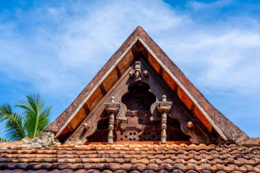 Punnamada Resort, Alappuzha, Kerala, India - 19.01.2023: Carving wood gable roof on a resort hotel in India, Alappuzha, Kerala. Wooden roof structure, traditional indian style. Hight quality photo. 