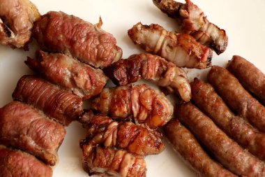 Mixed roast meat. Gnummareddi, rolls based on lamb offal, sausage and the bombette martinesi, meat rolls stuffed with cheese. High quality photo