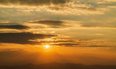 sunrise with clouds for background, light rays and other atmospheric effect. Bright orange sky and light of the sun. Sunset sky for background or sunrise sky and cloud at morning.