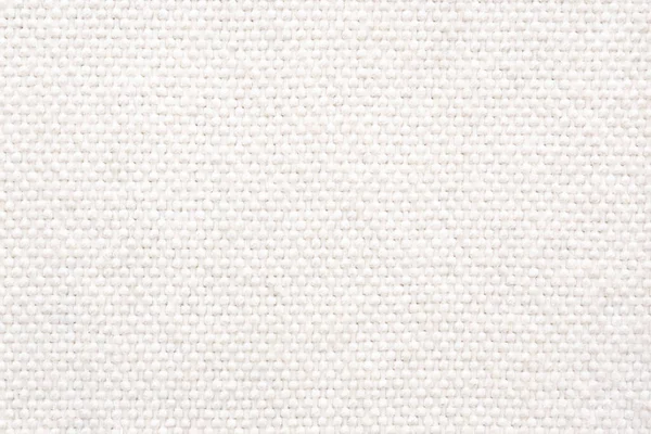 White wool braided area rug texture background, bathroom carpet. Close-up, top view.