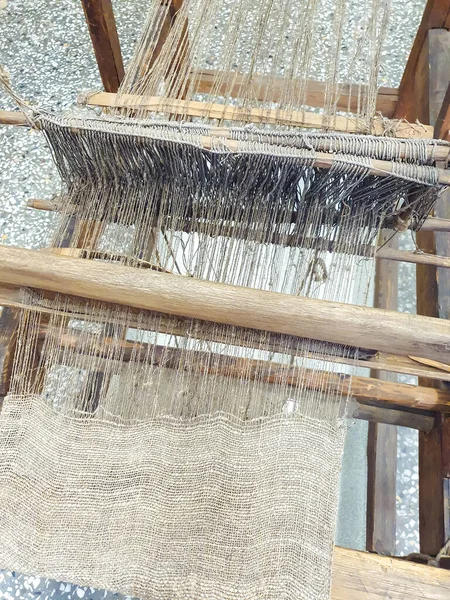 Old traditional hand weaving loom machine. Vertical photo.