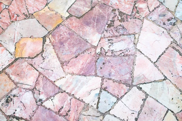 Pink marble texture background, floor. Natural stone, pieces of pink marble with dark seams, top view, full frame