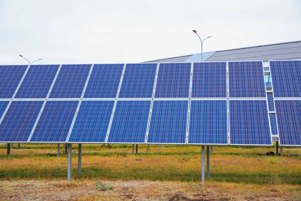 Solar power system. Ground mounted Solar power photovoltaic panels on grass in city, clean energy and environmental power from sunlight to reduce global warming around world. Lifestyle