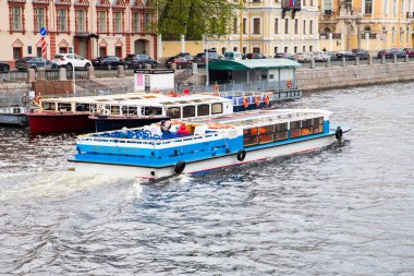 Canal cruise tourist boat, Cruise boat on Fontanka river channel of St Petersburg, Russia - 05.29.2022. View from bridge