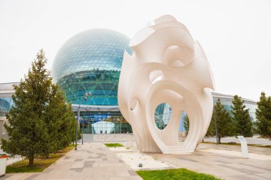 Round sphere modern building, Nur-Alem sphere EXPO 2017 Exhibition Area. Sculpture construction art Minima Maxima. Museum Energy of Future and street installation. Astana, Kazakhstan - 10.22.2022. clipart