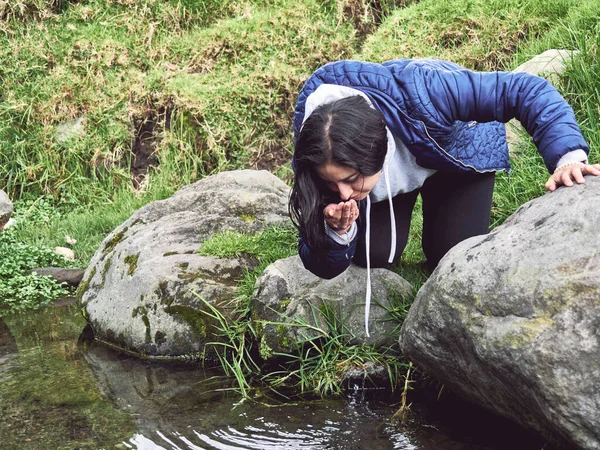 Embracing the Wild: Woman Hiking and Splashing Through a River, drink water
