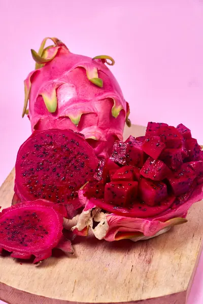 Red dragon fruit Set with appetizing serving Isolated on pink background. Top view, hand