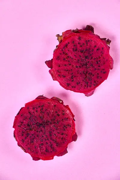 Red dragon fruit Set with appetizing serving Isolated on pink background. Top view, hand
