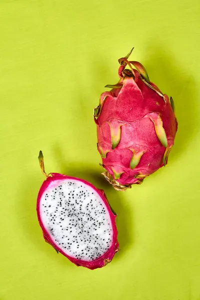 Red dragon fruit Set with appetizing serving Isolated on reen background. Top view, hand knife table