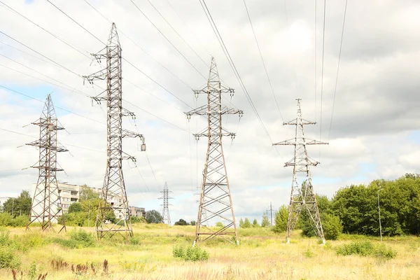 Stock image High voltage electric power lines on pylons in blue sky