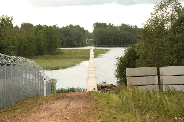 stock image KRASLAVA DISTRICT, LATVIA - AUGUST 8, 2023 Fence on the Latvia border with Belarus. Protective infrastructure