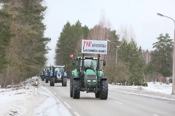 DAUGAVPILS, LATVIA - 5 Şubat 2024: Letonya 'da köylü protestosu. Traktörler, arabalar, tarım makineleri şehrin sokaklarında geziniyor.