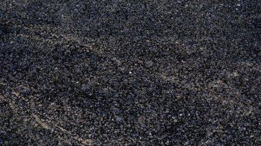 Stone chips melted on road due to high temperature in summer. clipart