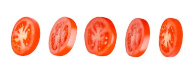 Flying tomatoes cut into circles. Tomatoes, tomatoes, cut, fresh tomatoes. Isolated. Horizontally. Divided.