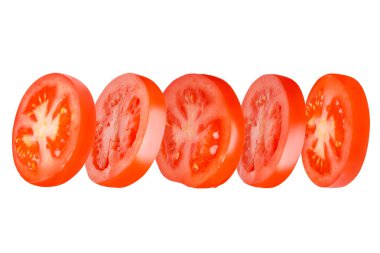 Flying tomatoes cut into circles. Tomatoes, tomatoes, cut, fresh tomatoes. Isolated. Horizontally.