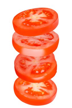 Flying tomatoes cut into circles. Tomatoes, tomatoes, cut, fresh tomatoes. Isolated. Vertical
