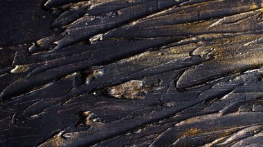 Consistency dark rough sections with golden sparkles