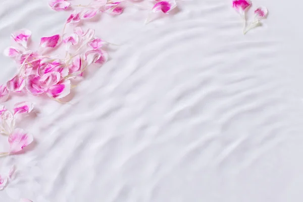 Rose petals in water. Waves, water, petals. floral, water Dripping, pouring.
