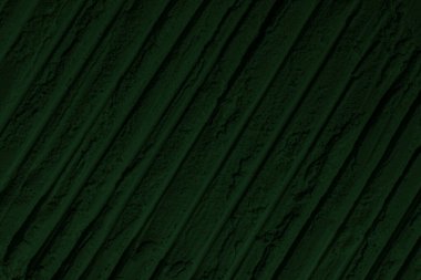 Küresel ısınma kavramı, tasarlamak için alanı olan siyah yeşil arka plan. Eski bir taş duvarın kabataslak yüzeyi. Yakın plan. Koyu yeşil zümrüt rengi. Geçmişi. Katı. Grunge. yeşil göz farı. Kraterler. yeşil toprak