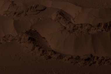 Kil, kum, toprak dokusu. Kahverengi. Geçmişi. Çatlak, çatlak, dalga, dağ, çember, oyuk. girintilenmiş