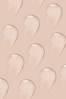 Arka plan kozmetik. Pembe bir arkaplanda saydam jel lekeleri var.