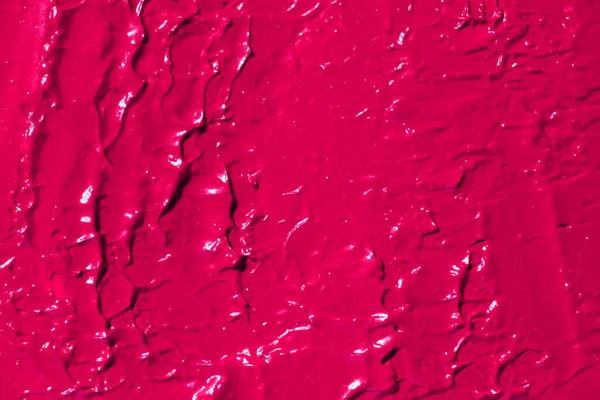 The texture of lipstick, lip gloss, paint, completely filled in the background. pink color.