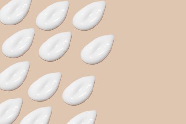 Bej bir arka planda beyaz krema darbeleri.. 