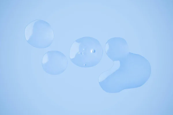 Gotas Gel Transparente Traços Gel Manchar Gel Num Fundo Azul — Fotografia de Stock