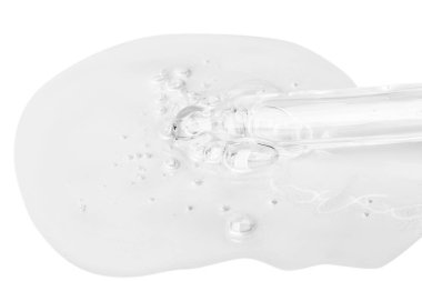 Damlatıcıdan şeffaf jeli açık bir hatla sızdırıyor. Jeldeki kabarcıklar. Jel dokusu. Beyaz bir arkaplanda izole edilmiş.