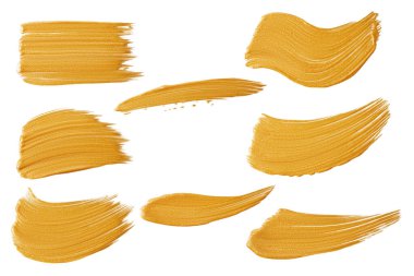 Beyaz arka planda bir dizi altın rengi boya..