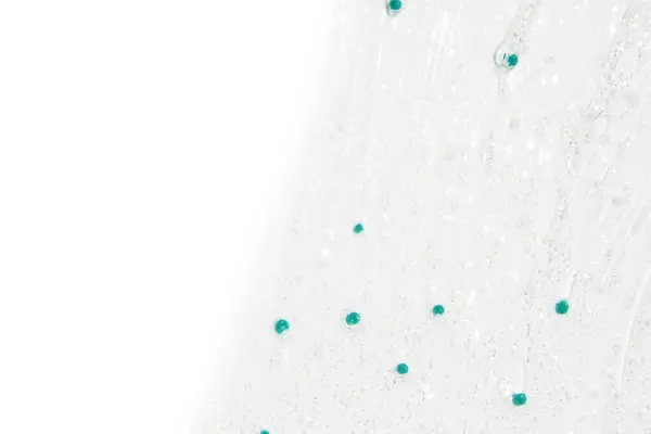 Průhledný Gel Modrými Granulemi Rozmazané Sérum Bílém Pozadí — Stock fotografie