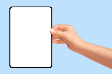 Mavi zemin üzerinde boş ekran bulunan tableti tutan kadın