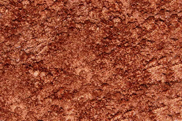 A bright background of scattered glitter shadows in brick or orange shades